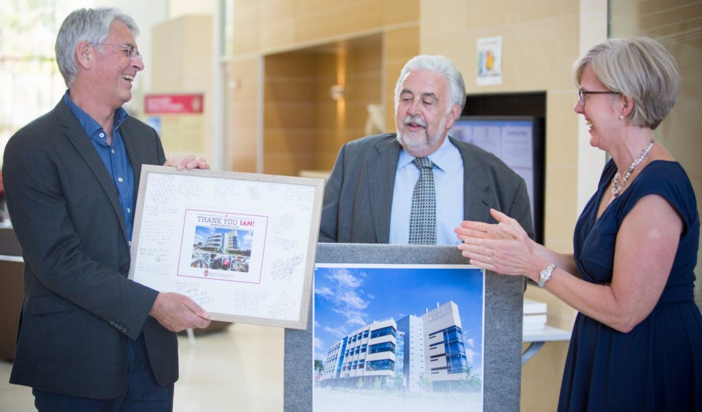Former Wisconsin Energy Institute (WEI) Interim Director Ian Coxhead (left) receives a gift thanking him for his tenure from (middle) Incoming WEI Director Tim Donohue and (right) WEI Associate Director Mary Blanchard. 