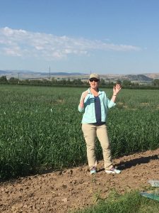 Photo of Mary Burrows talking to farmers