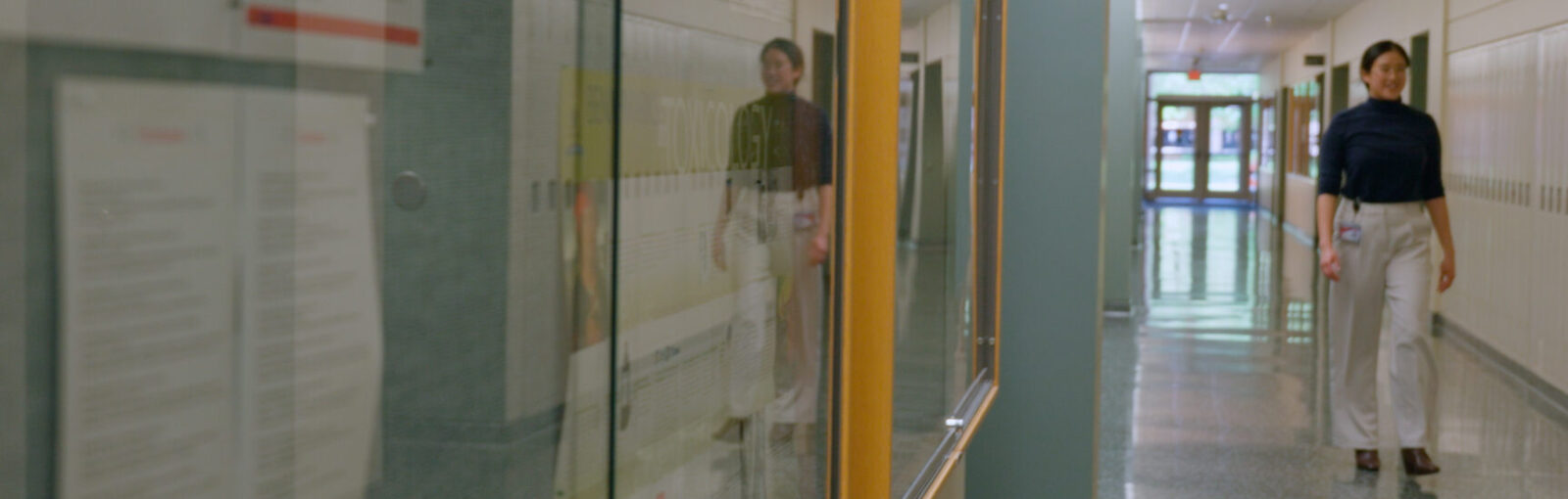 Jennifer Tran walks down the hall of Pharmacy School Building