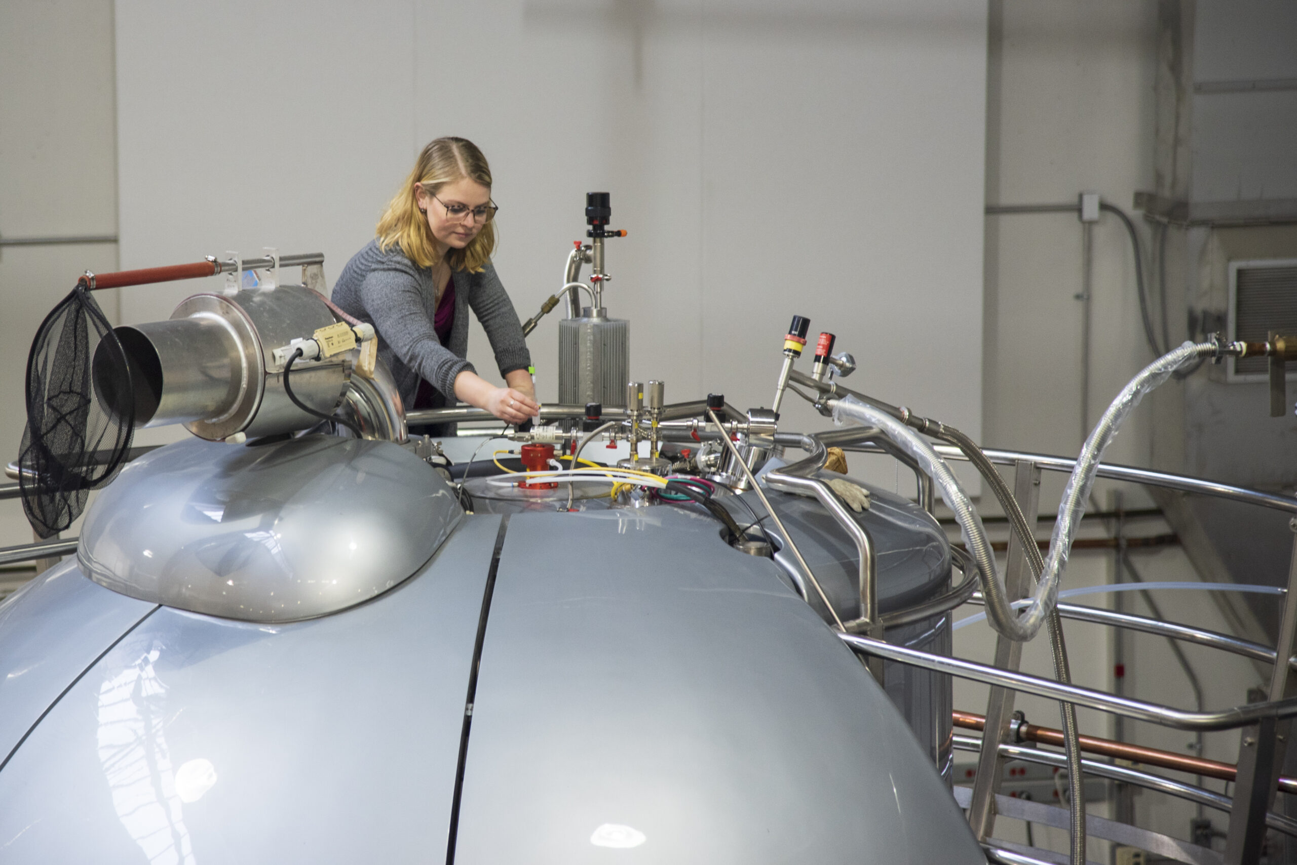 Photo of BTP student loading a tube in the 900 MHz NMR Spectrometer